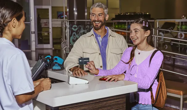 Father with daughter using Greenlight debit card