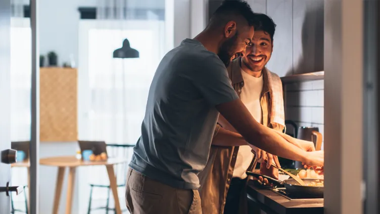 Two men cooking a meal together