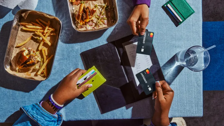 Teens using Greenlight debit card to pay for meal