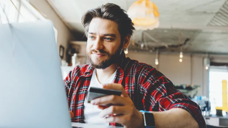 Man with debit card in hand