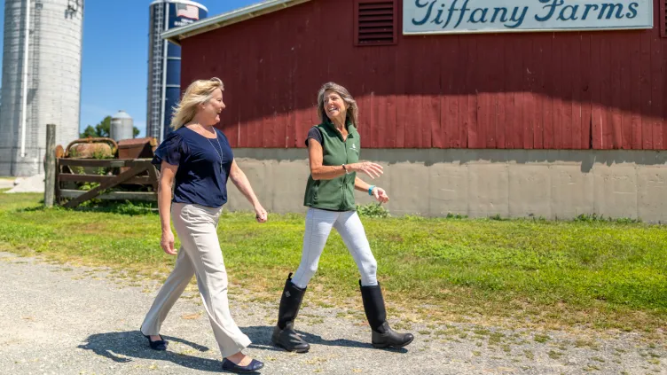 Essex Bank officer walking with Jen Tiffany at Tiffany Farms
